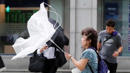 Woman struggles against strong wind
