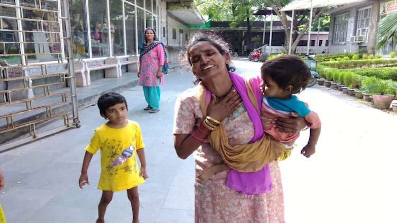 Rani, wife of sanitation worker Anil, with her children 