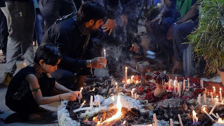 Muslim girl lights candles to mark Ashura