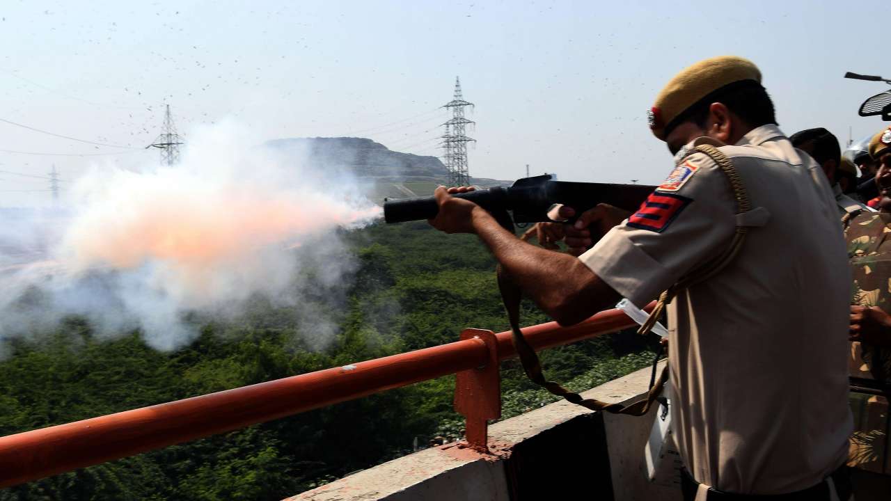 Police official fires tear gas at farmers on Tuesday Police official fires tear gas at farmers on Tuesday