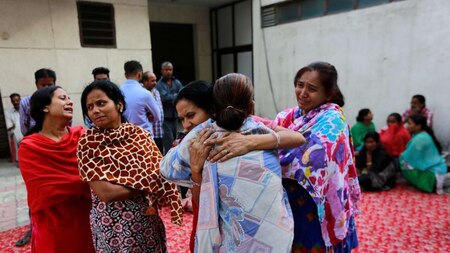 Women mourn the death of their relatives
