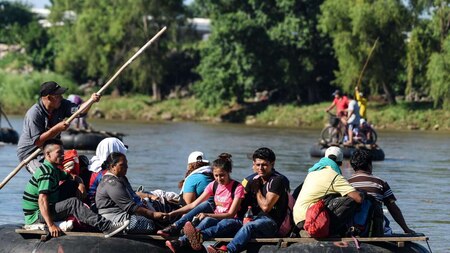 Migrants cross the Suchiate River