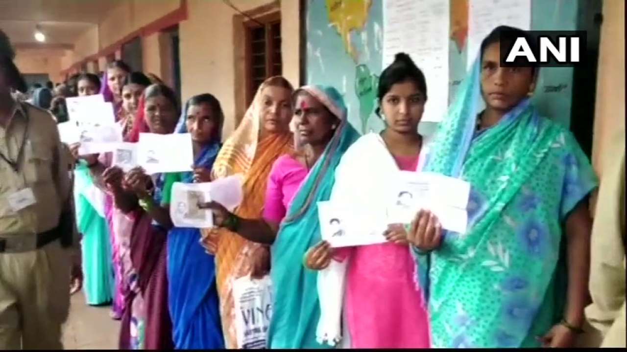 People queue up outside a polling booth in Jamkhandi, ANI