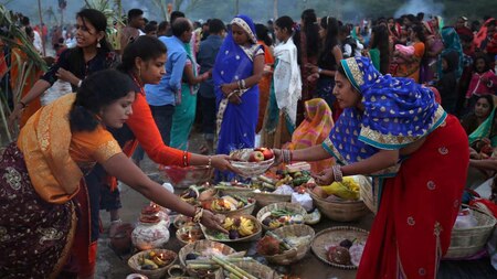 Devotees collect offerings before worshipping