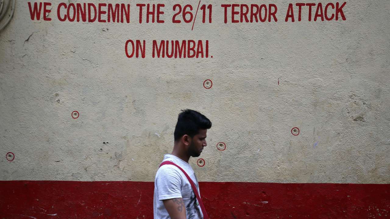 Wall riddled with bullet holes opposite Nariman House