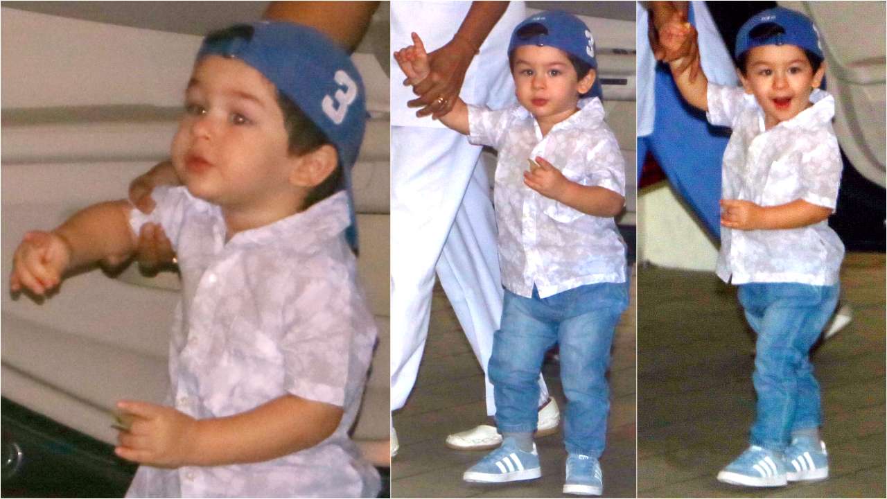 A cap, transparent white shirt and blue denims - That's Taimur for you