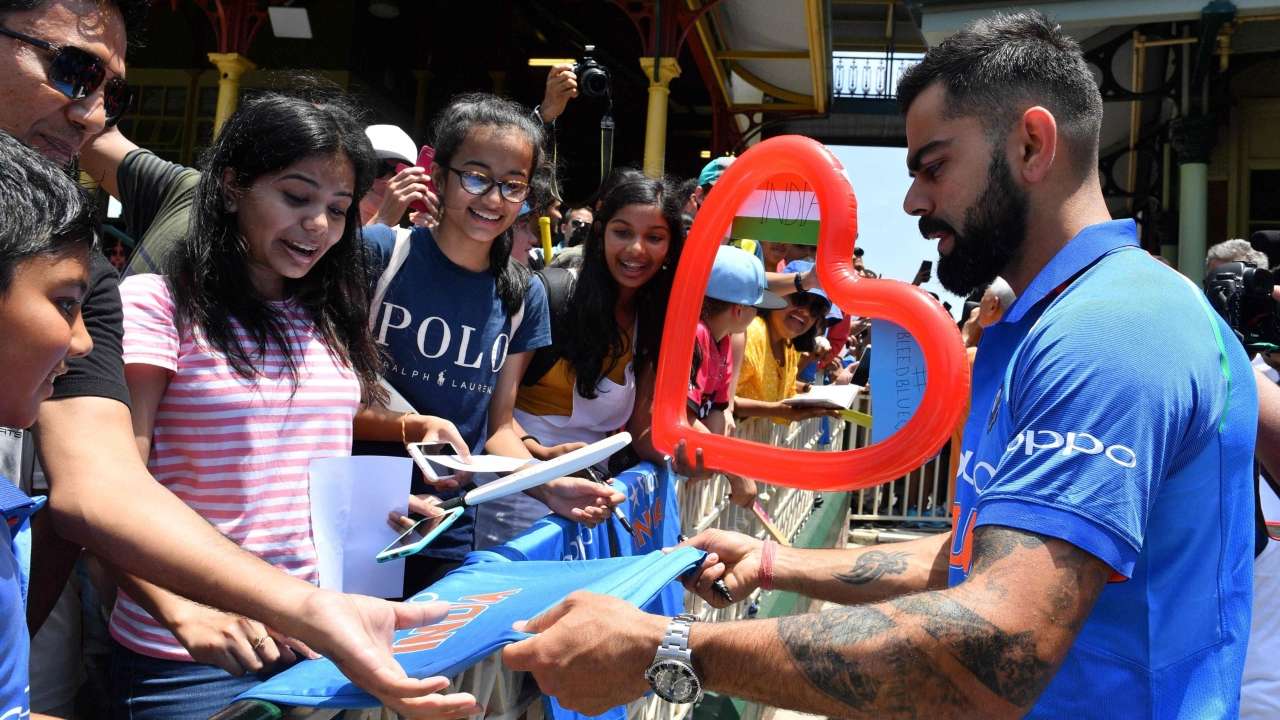 Virat Kohli signs autographs for fans at the Sydney Cricket Ground