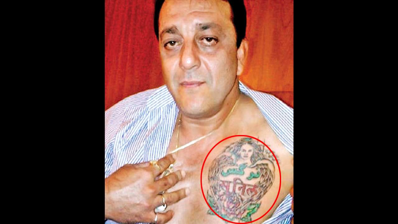 Sixpack abs pony tail and a tattoo Sanjay Dutt walks out of jail in  style  India Today