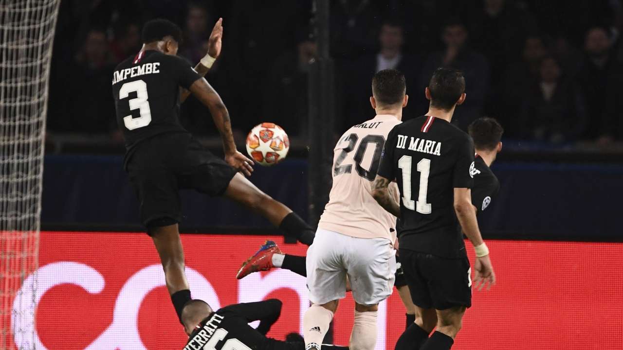 PSG's Presnel Kimpembe (C) makes a hand fault leading to a penalty