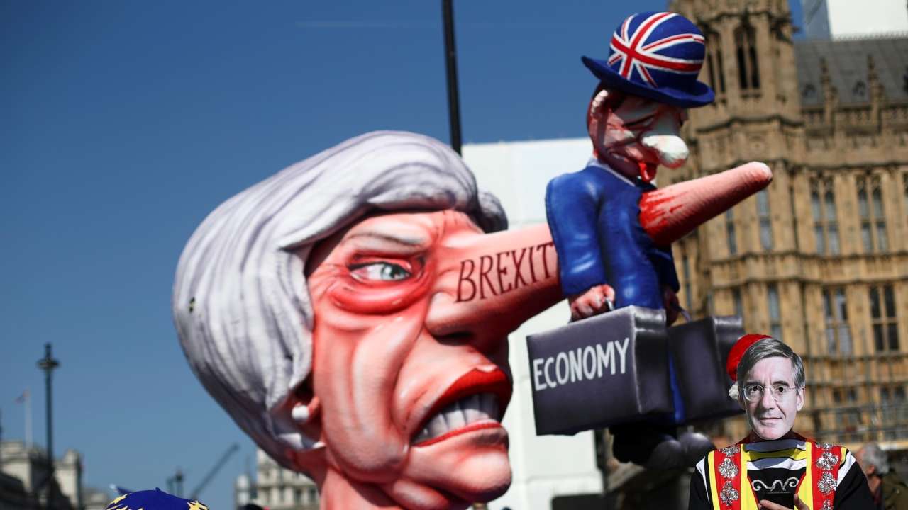  man wearing a mask of Britains Conservative Party MP Jacob Rees-Mogg is pictured next to anti-Brexit protesters