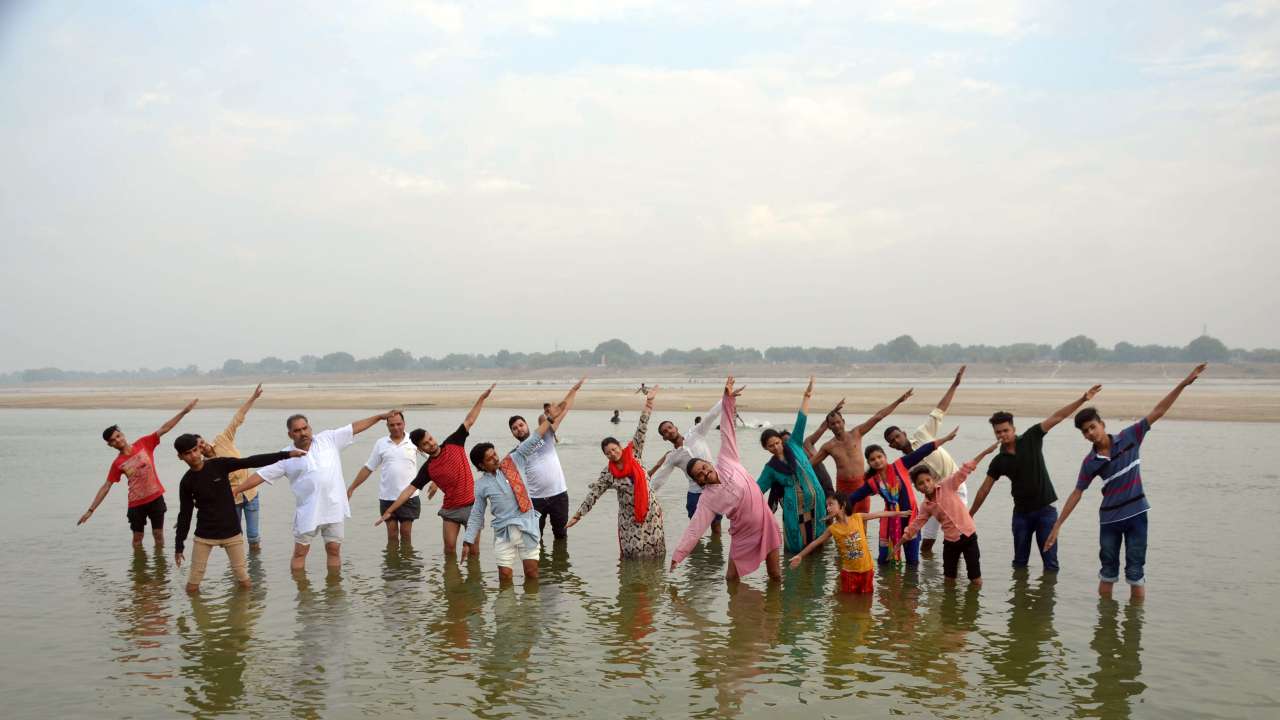People participate in a yoga session at the river Ganga on the eve of International Yoga Day 2019 in Mirzapur on Thursday