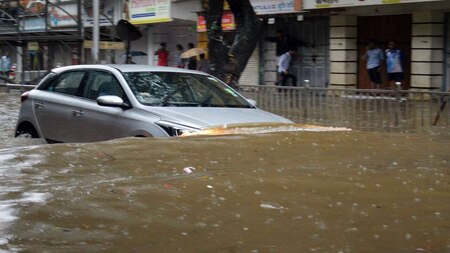 Car passes through a waterlogged street in Mumbai