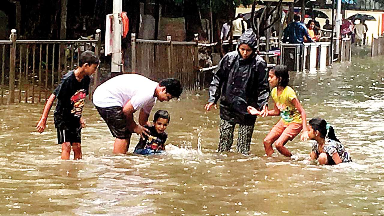 Mumbai rains; Kids play on inundated King's Circle road