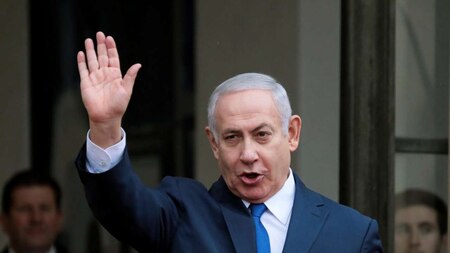 Israeli Prime Minister Benjamin Netanyahu waves as he arrives