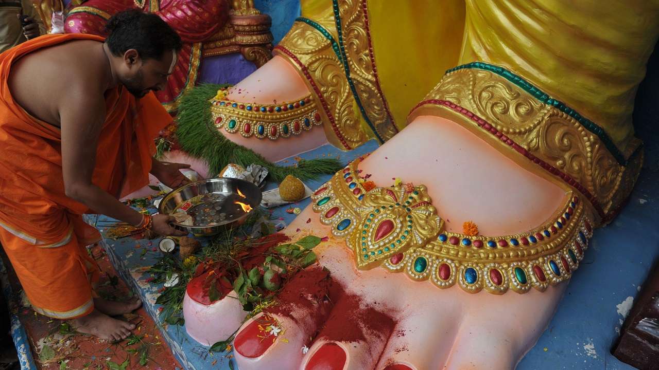 Priest offers prayers to Lord Ganesha