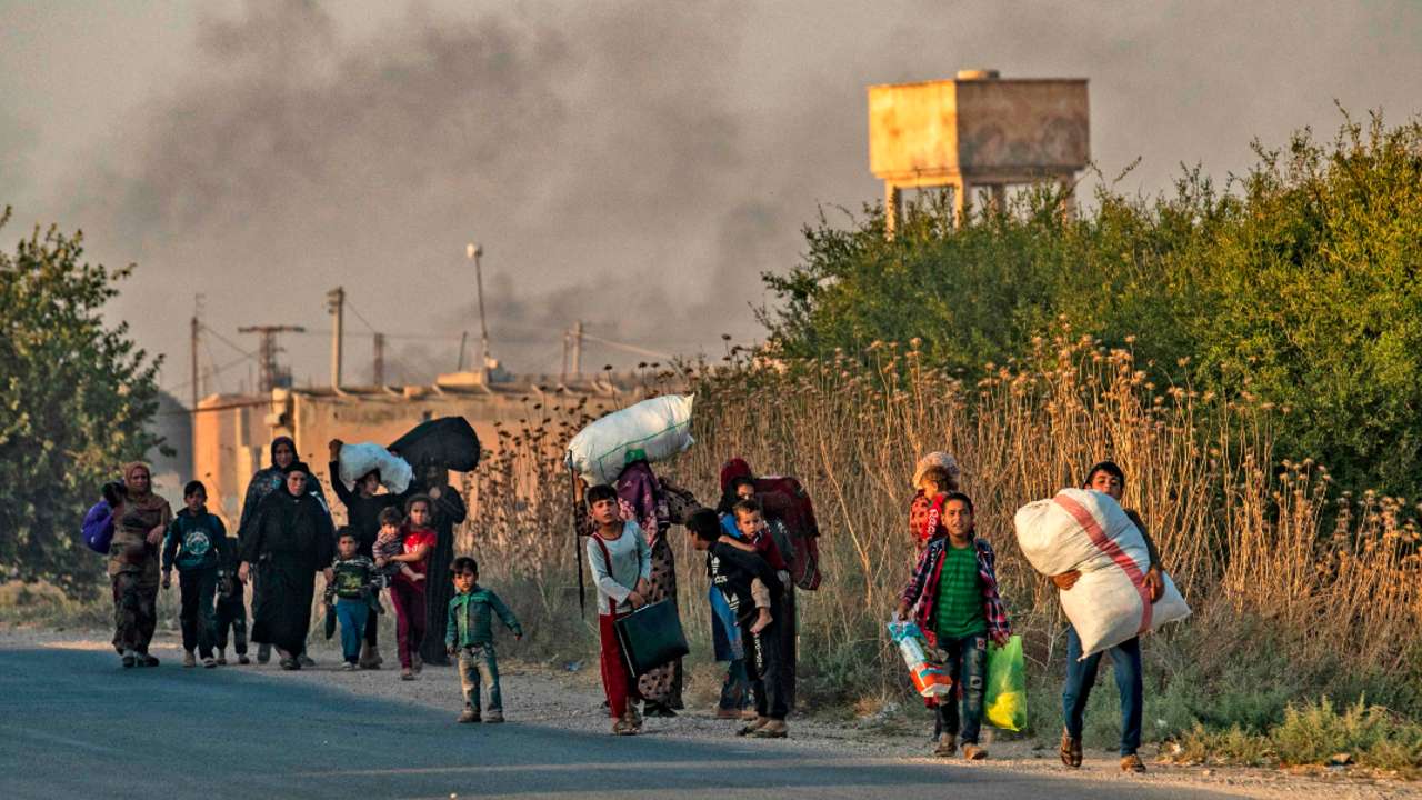 Thousands of civilians flee border towns as Turkey kicks off offensive in Syria