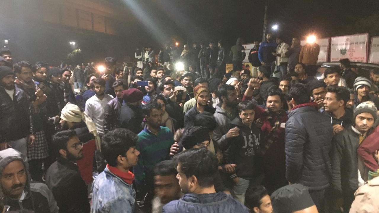 Delhi: People gather in protest outside Jamia Nagar Police station after gunshots were heard near Gate 5 of the JMI university