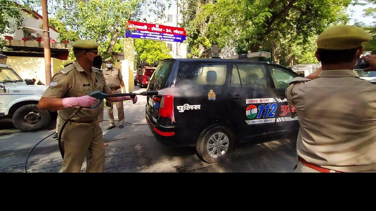 A police car being sanitised outside Noida Sector 24 Police Station