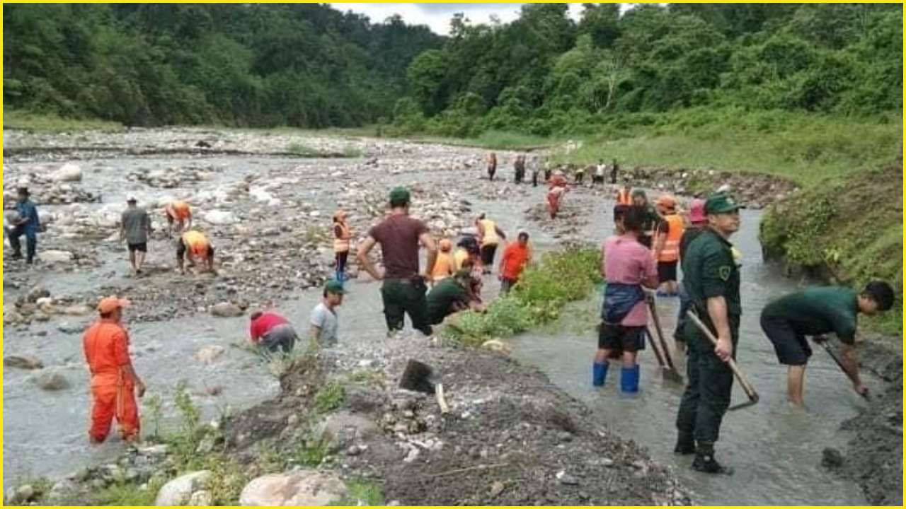 Bhutanese workers repairing irrigation channels