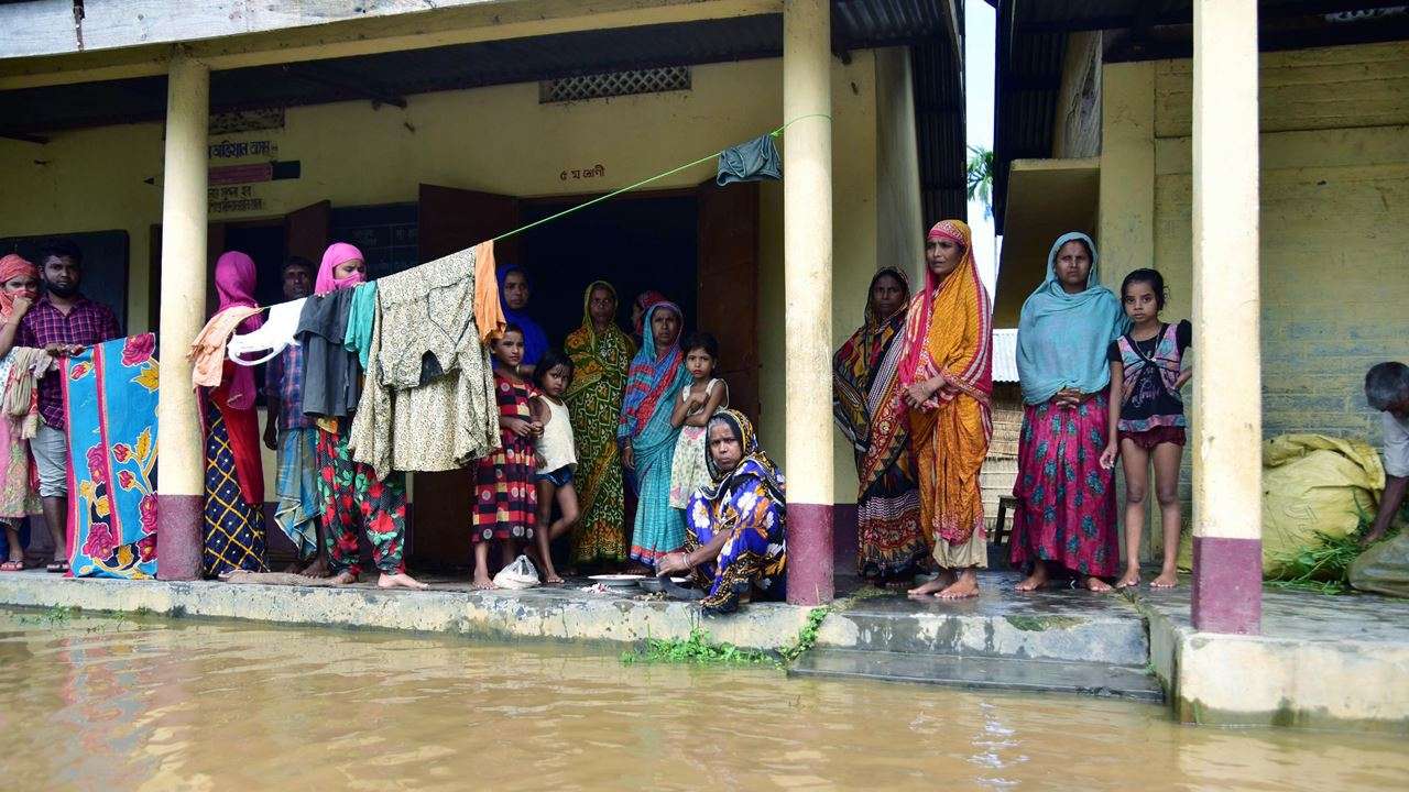 Villagers affected by a flood take shelter at a school, at Madhabpara village in Nagaon district