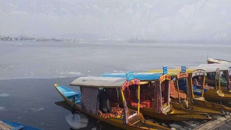 Boats lined up on frozen Dal Lake