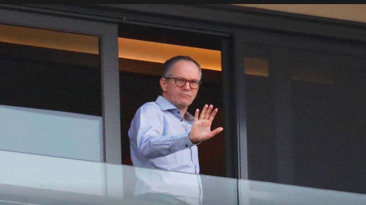 A member of WHO team waves from balcony