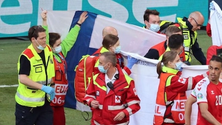 Finland fans offer flags to shield Christian Eriksen