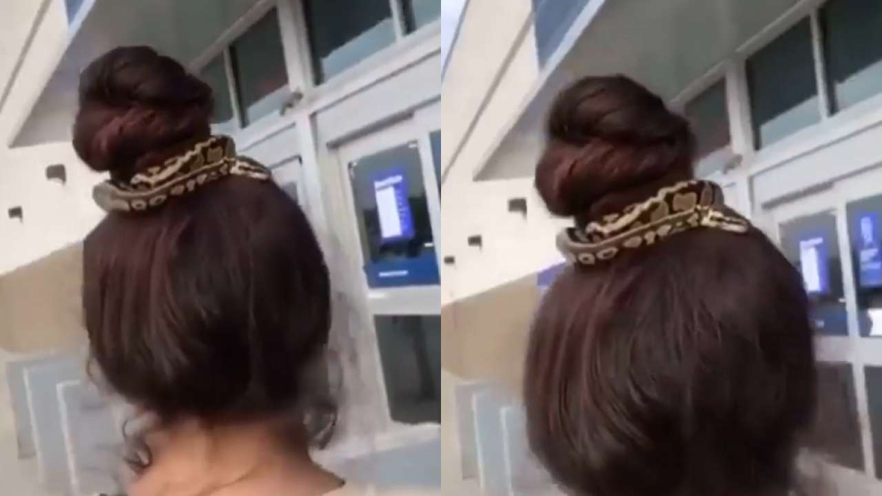 Shocking! Woman uses snake as hair tie, roams around in mall - WATCH viral video Shocking! Woman uses snake as hair tie, roams around in mall - WATCH viral video