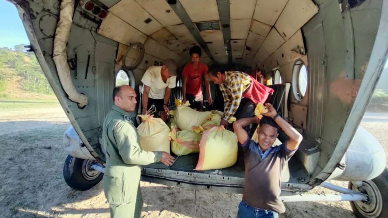 Indian Air Force personnel deliver relief supplies in flood-affected area