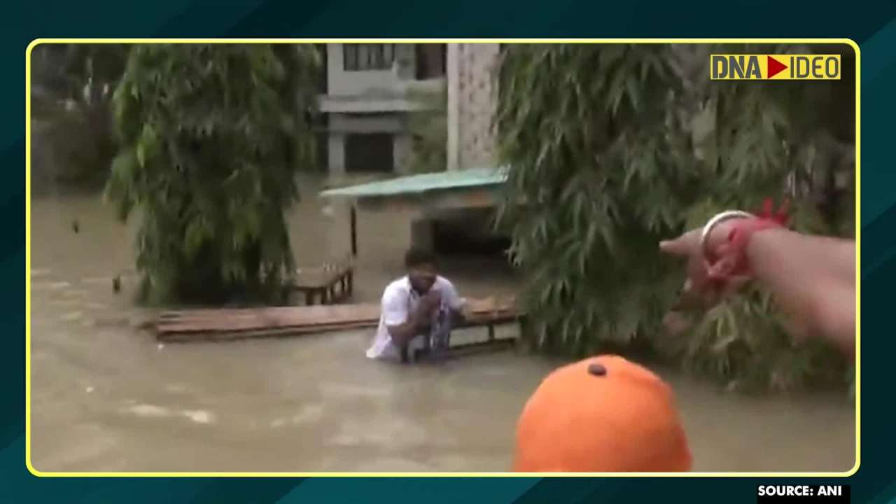 Assam floods: Man wades through waist-deep water to greet Assam Chief Minister with gamusa 