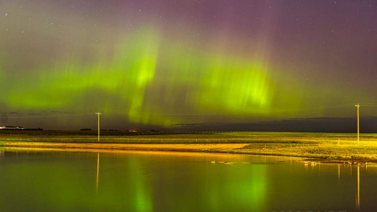 Reddish-greenish light emerging in sky