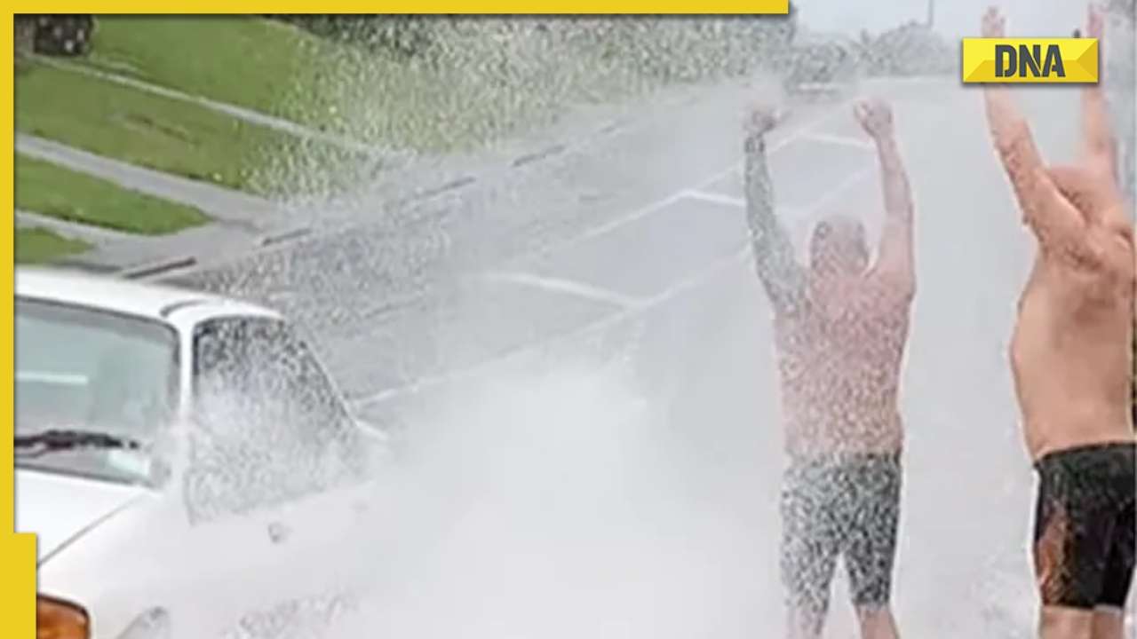 Men wait for cars to splash water on them, viral video delights