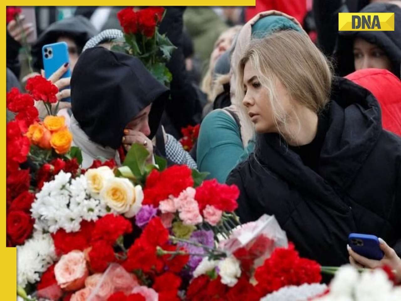 Russians lower flags, lay flowers to honour concert hall attack victims