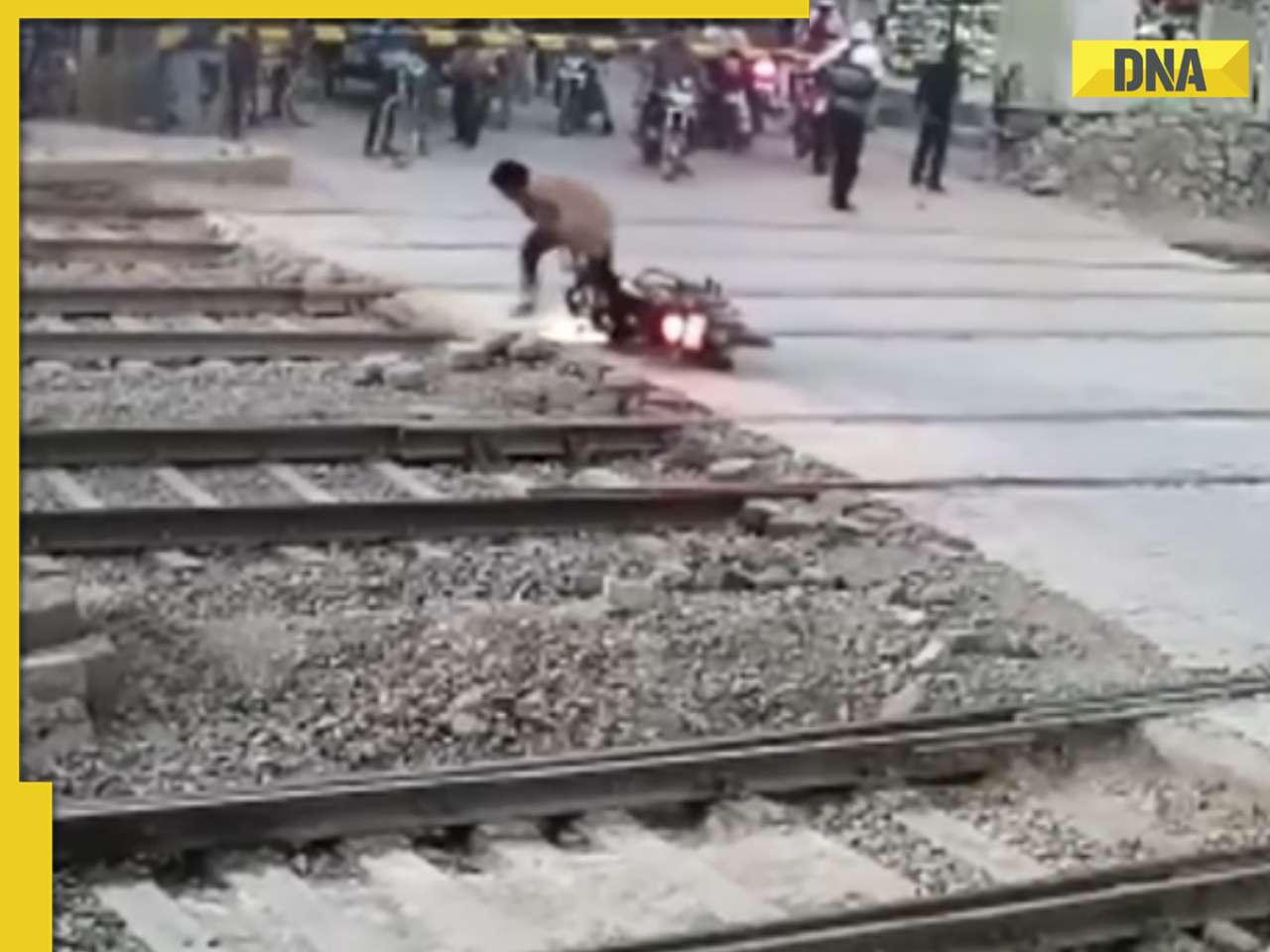 Viral video: Biker narrowly escapes death by inches at railway crossing, watch