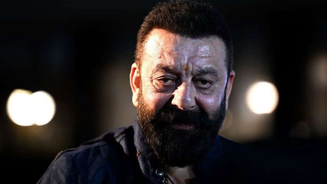 Businessman beyond big screen