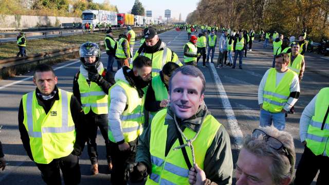 France A man wears a mask with the likeness of French president Emmanuel Macron during a fuel price protest