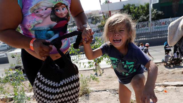 Girl cries after running away from tear gas 