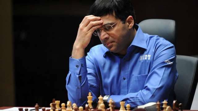 V. P. Kaushik, 11, watches as Indian World Rapid Chess Champion Viswanathan  Anand, unseen right, makes a move at the launch of a school chess  tournament organized by the NIIT Mind Champion's