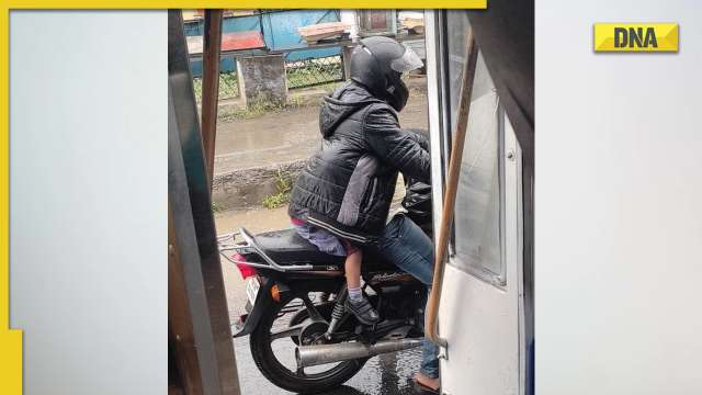 Dads are underrated: This viral pic of father protecting his child from rain melts hearts online - Vimarsana News