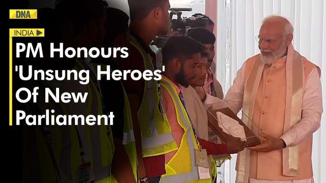 PM Modi felicitates workers who helped in building new Parli...