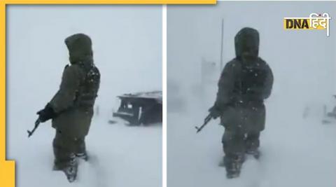 Indian Army Soldier stands during snow fall.