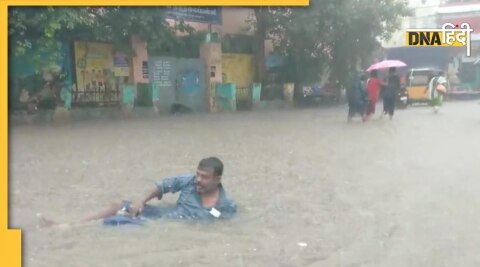 man try to swim in waterlogged in street