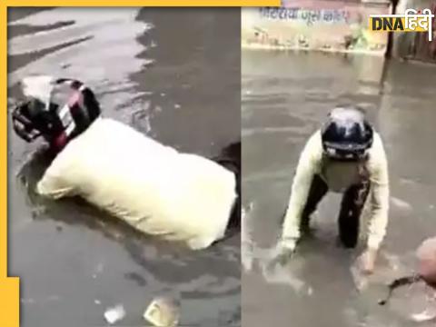 delhi rain man lost his bike drowned in drain sangam vihar watch viral video 