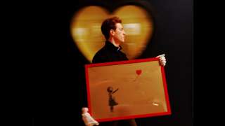 Banksy's balloon girl painting self-destructs moments after being sold...