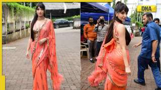 Nora Fatehi looks sizzling hot in orange saree featuring plunging neckline, check out photos