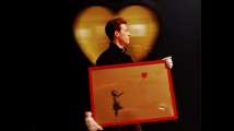 Banksy's balloon girl painting self-destructs moments after being...