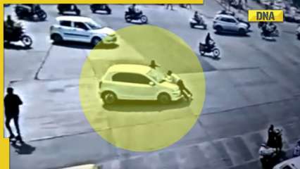 WATCH: Driver tries to run over traffic cop to avoid challan, he hangs tight on car’s bonnet for 4 kms